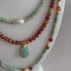Three necklaces in varying lengths. All with aquamarine, carnelian and pearls.
