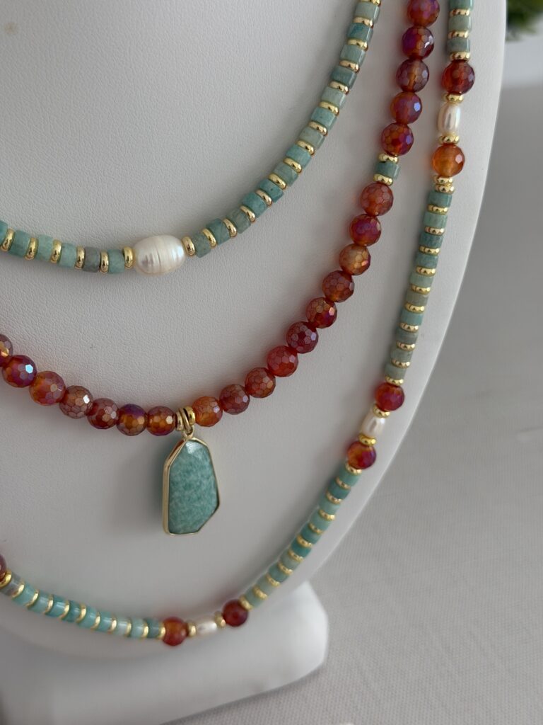 Three necklaces in varying lengths. All with aquamarine, carnelian and pearls.