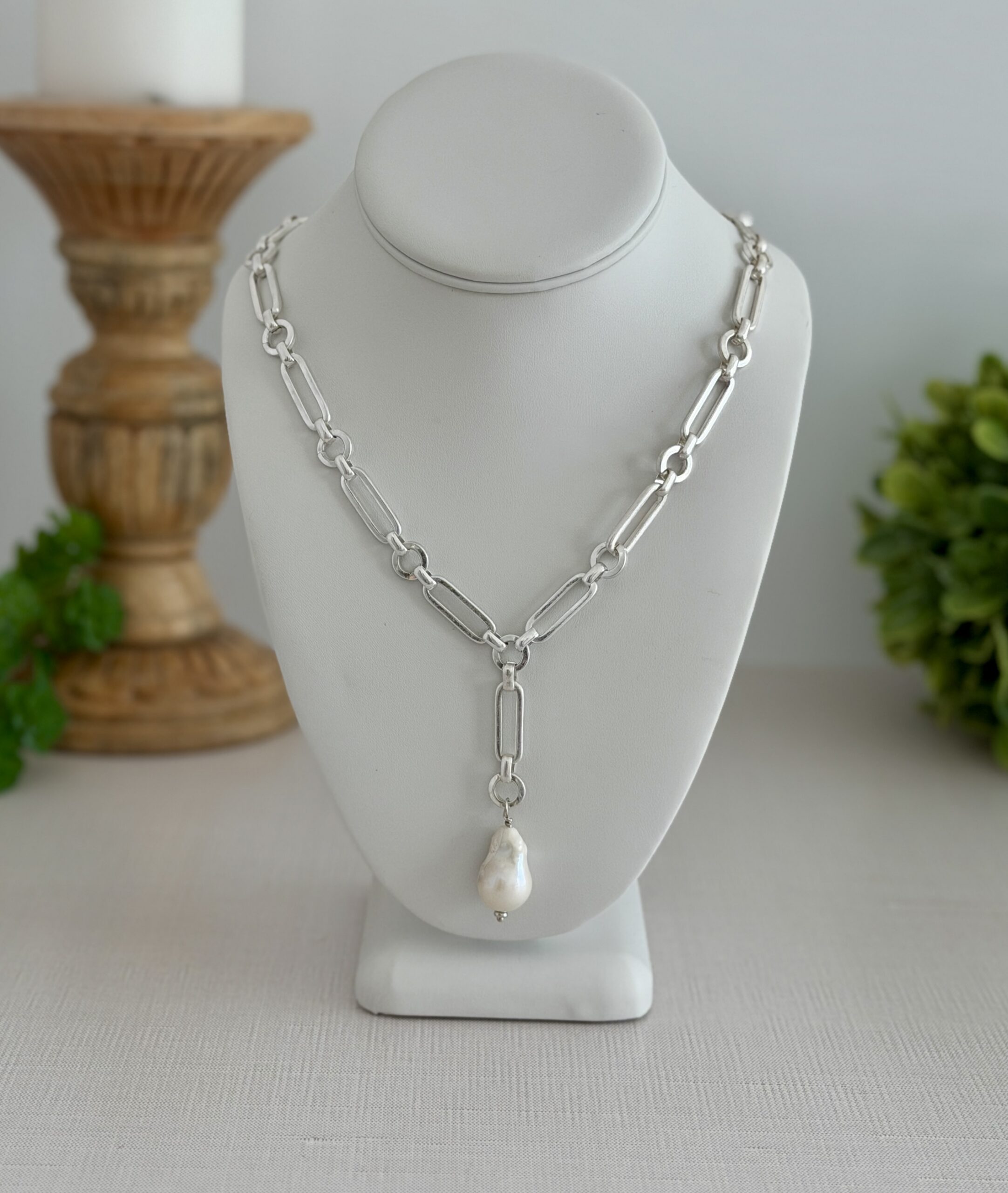 Matte silver chain necklace with a large baroque pearl. The clasp is a lobster style