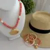 Coral colored beads called Botswana Agate with a shell focal pendant. Freshwater pearl stations