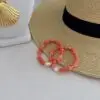 Botswana agate bracelet in coral with a centered pearl