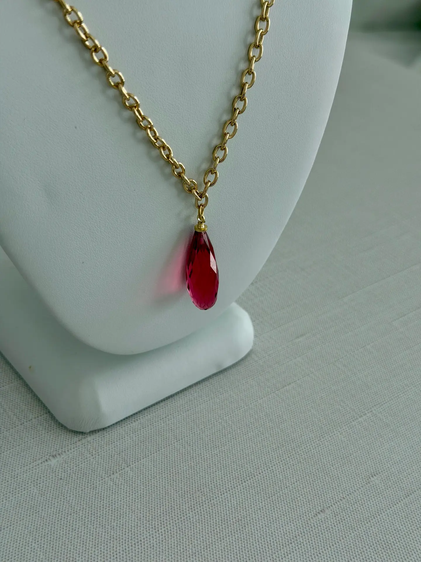 Rose quartz in a raspberry pink teardrop necklace. 18’ long and on a gold plated chain.