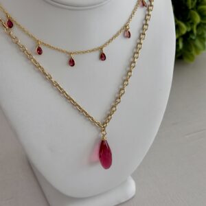Layered raspberry colored rose quartz necklaces.
