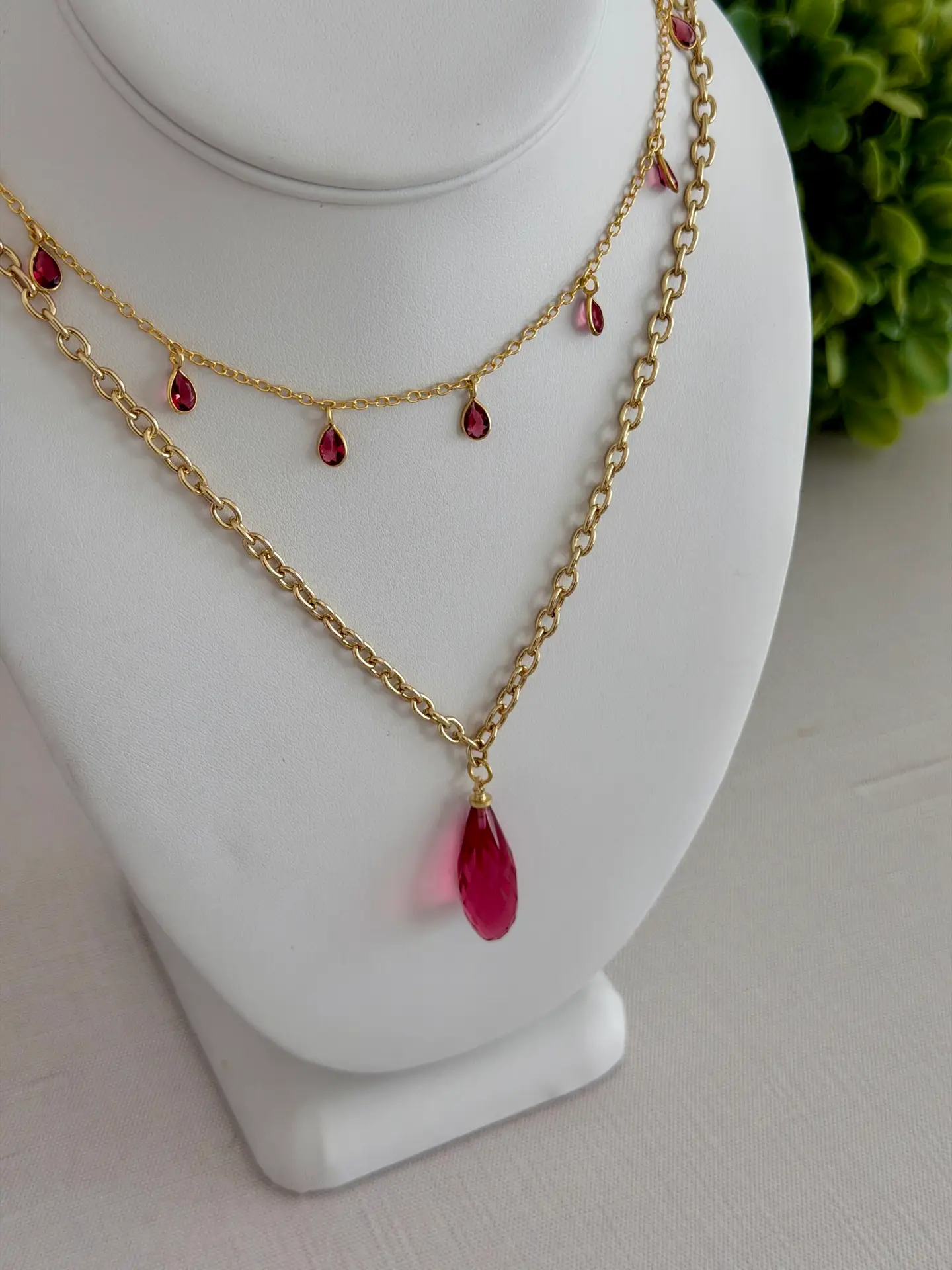 Layered raspberry colored rose quartz necklaces.