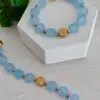 Blue gemstone bracelet with a magnetic clasp and a tree bead in brass gold.