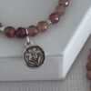 Mystic rose quartz gemstone stretch bracelet with a garden flower charm in a pewter tone.