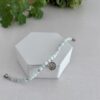 Blue lace agate gemstone bracelet with flower charm. It has a magnetic closure in silver