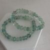 Fluorite is a beautiful gemstone as seen in this bracelet. The beads are rondelle in shape and have facets that really catch the light. The accents are in a silver to compliment the cool aqua green tones. The bracelet is a stretch style and is a size seven or seven inches long.