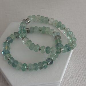 Fluorite is a beautiful gemstone as seen in this bracelet. The beads are rondelle in shape and have facets that really catch the light.  The accents are in a silver to compliment the cool aqua green tones.  The bracelet is a stretch style and is a size seven or seven inches long.  