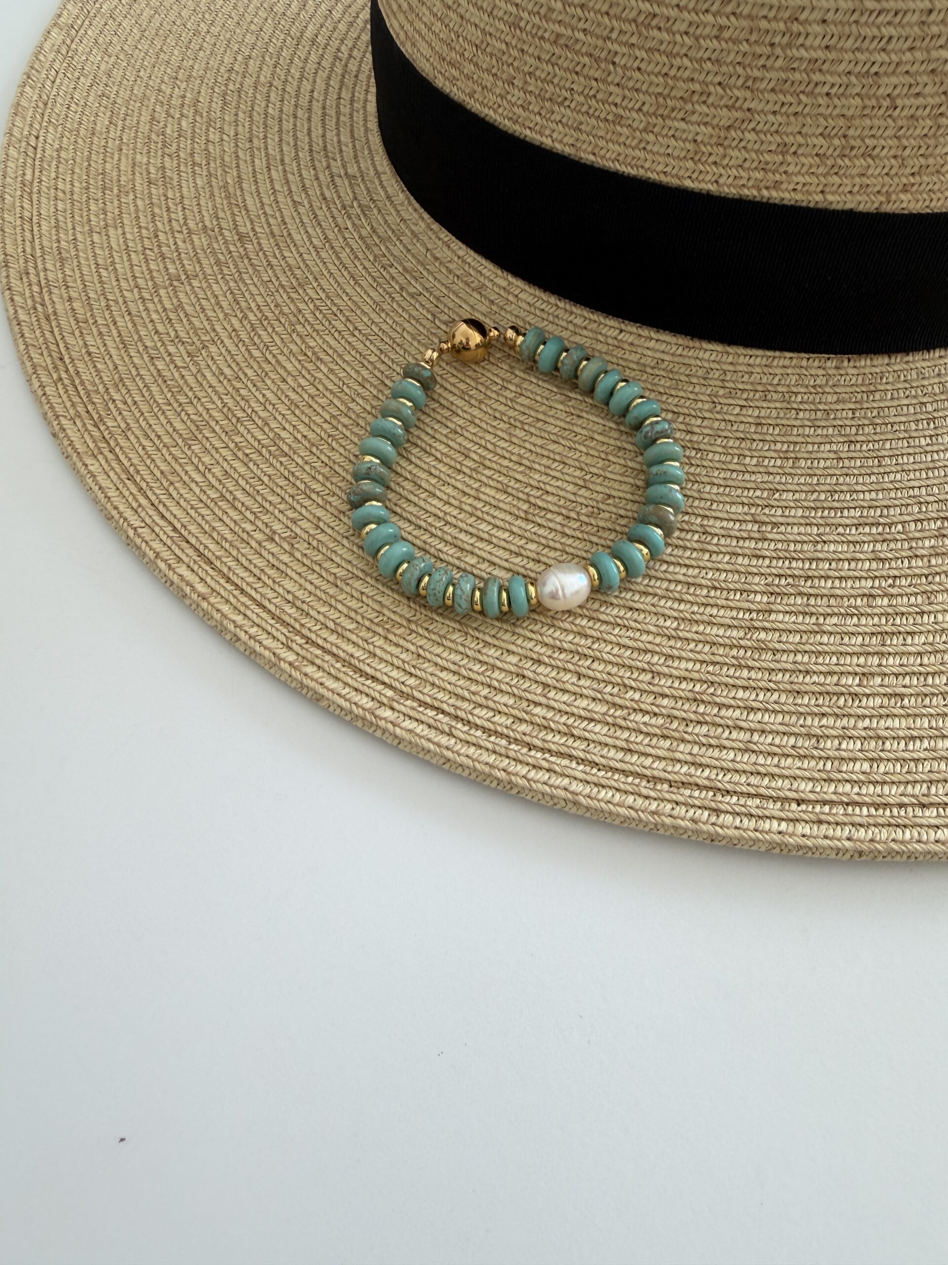 American Turquoise bracelet with a pearl focal center bead. The bracelet is magnetic