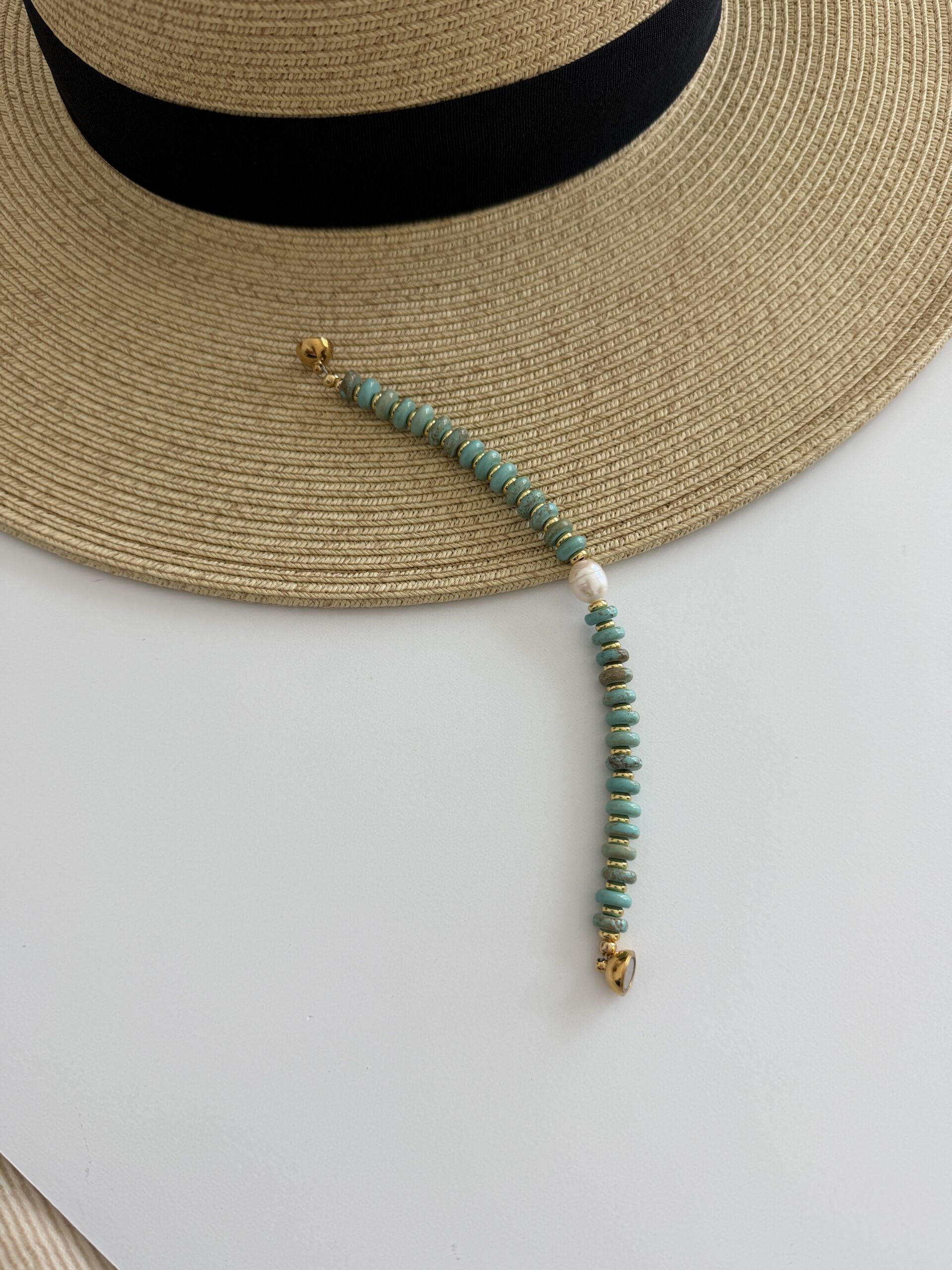American Turquoise bracelet with a pearl focal center bead. The bracelet is magnetic