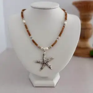 Brown hessonite garnet necklace. 16” it has a starfish pendant in silver, has fresh water pearls creating stations of interest every 2 inches. A lobster style clasp for the closure