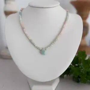 cube shaped beryl gemstone beads in 4mm ombré in color to a natural aquamarine teardrop focal pendant. The necklace is approximately 17” long and has a lobster claw closure in a fold finish