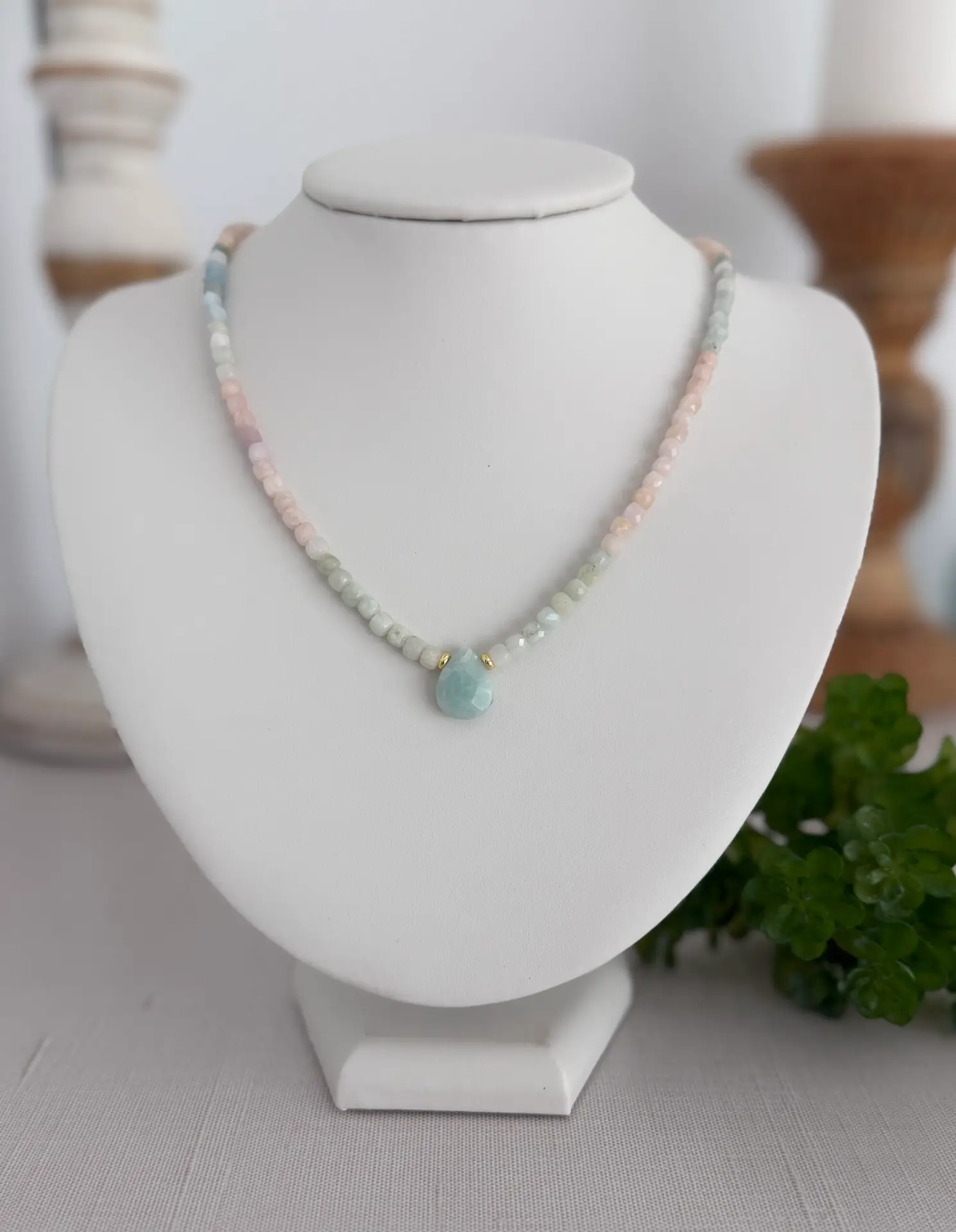 cube shaped beryl gemstone beads in 4mm ombré in color to a natural aquamarine teardrop focal pendant. The necklace is approximately 17” long and has a lobster claw closure in a fold finish