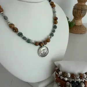 This necklace is. Earthy in tones and design! The picture jasper is in a warm caramel brown. The green apatite is in soft sages and two different cuts. One is a round and one is a coin cut bead.  The antique silver pendant is two sided and has a raised garden design of a dragonfly.  The necklace is approximately 17” long and has a lobster claw closure.