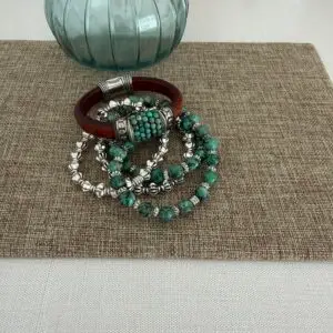 The leather is a Portuguese leather and the gemstone is an African turquoise. The silver accents are perfect for the stone! The leather bracelet has a magnetic clasp. The four matching bracelets are all stretch in style. Two are turquoise and two are a silver tone for creating a smashing look!
