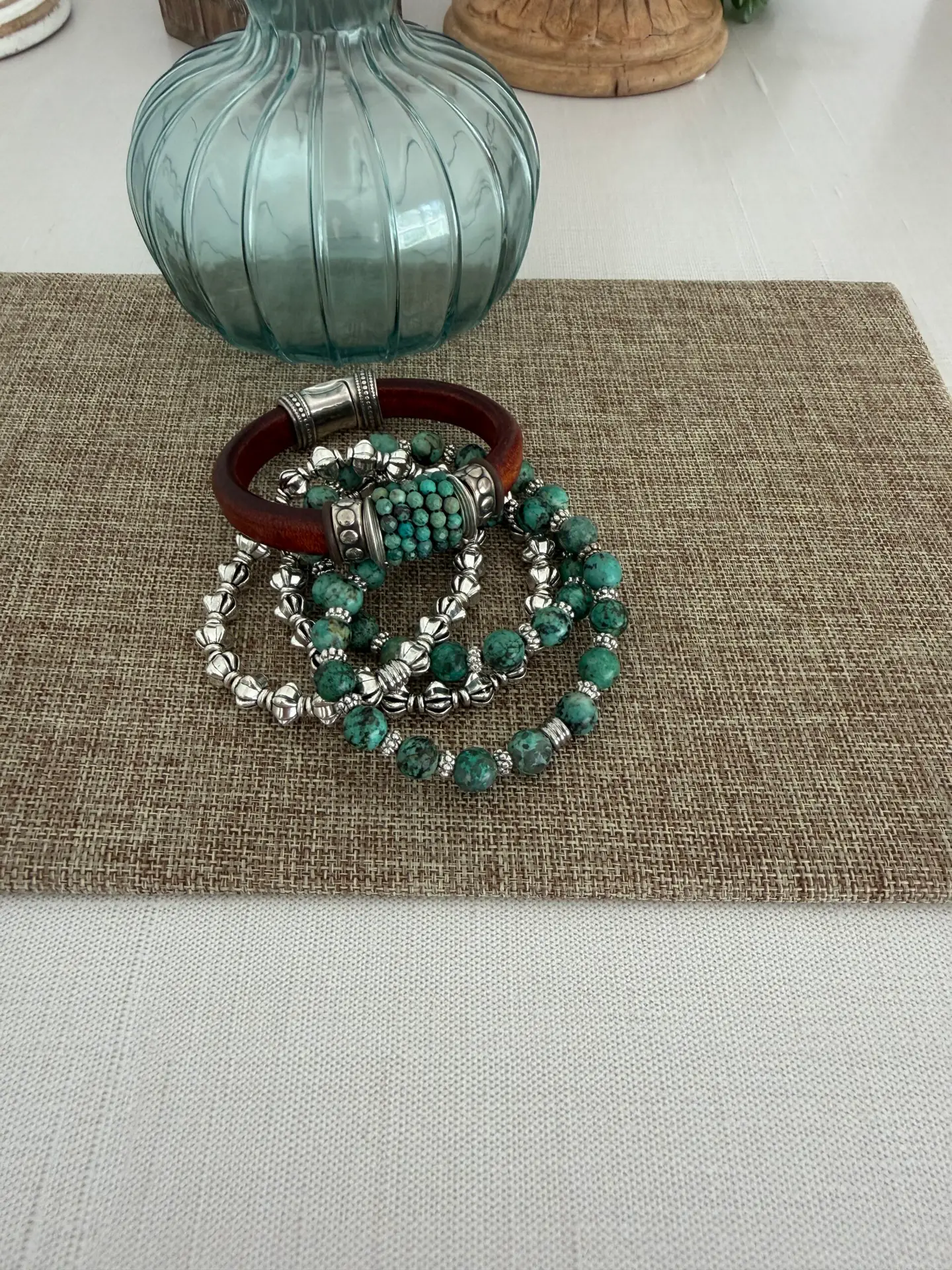 The leather is a Portuguese leather and the gemstone is an African turquoise. The silver accents are perfect for the stone! The leather bracelet has a magnetic clasp. The four matching bracelets are all stretch in style. Two are turquoise and two are a silver tone for creating a smashing look!