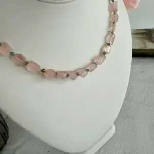 Pink strawberry quartz in angular cut beads are separated by green amethyst beads. The necklace is approximately