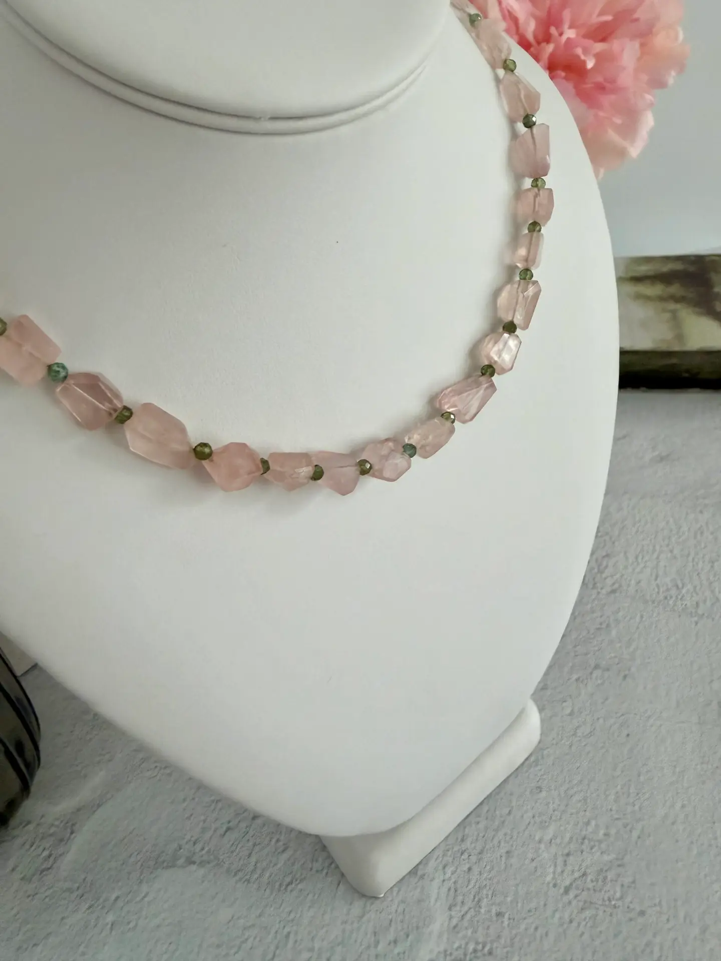 Pink strawberry quartz in angular cut beads are separated by green amethyst beads. The necklace is approximately