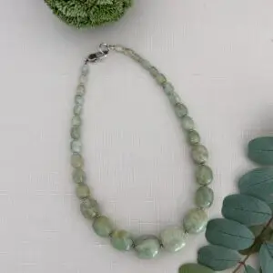 This amazonite gemstone necklace is exquisite. Known for its healing properties it is also associated with fertility and good luck. The color is a soft green, blue green and the polish is a high shine which really shows off the stone so nicely. The barrel beads are graduate from large to small at the clasp. The length is approxiamately 18 inches long and the gemstone necklace boasts a lobster claw clasp.